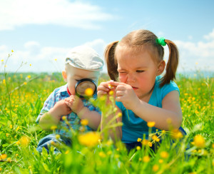 Children are playing on green meadow